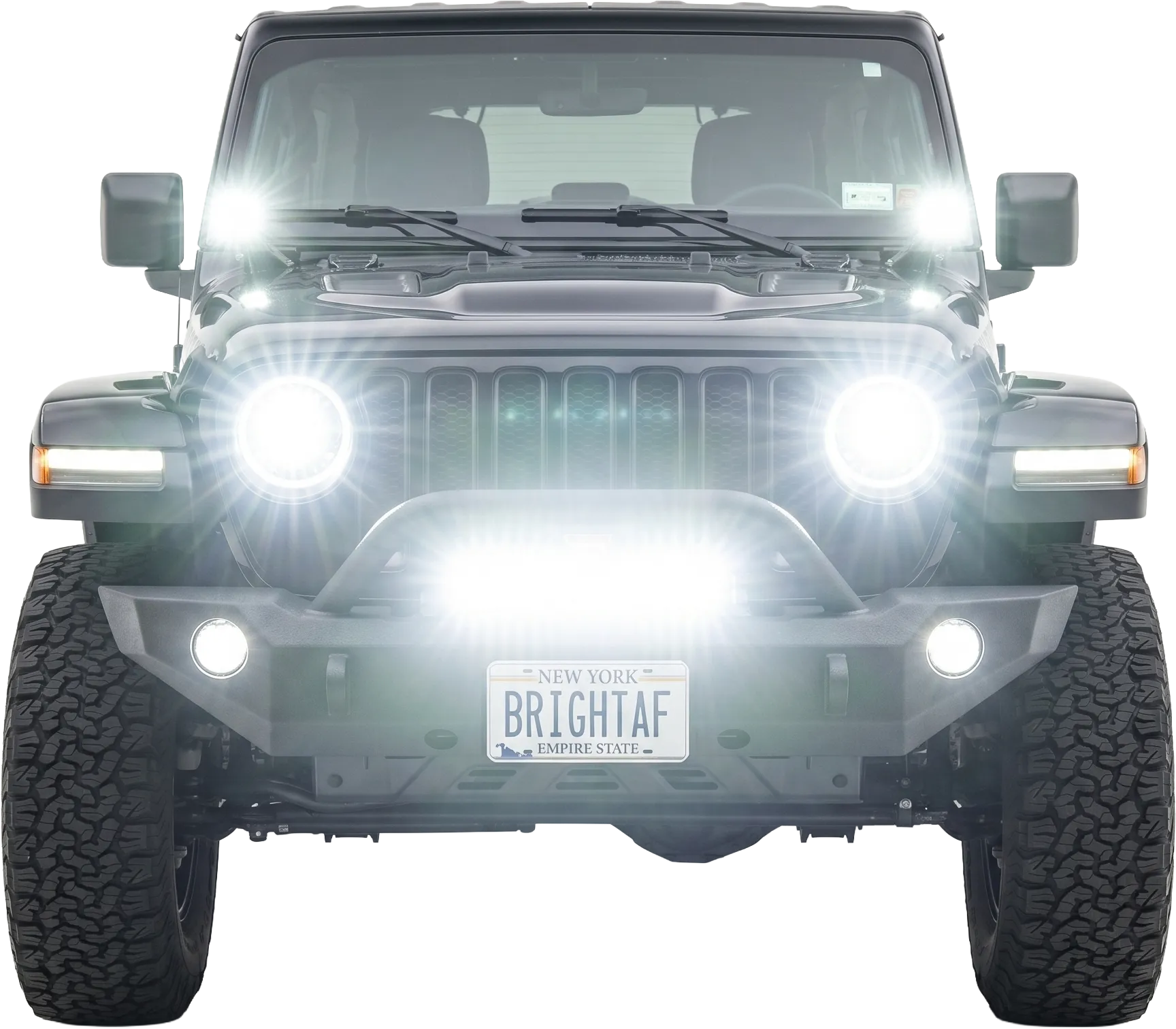 Jeep Wrangler JL with LED headlights, fog lights, light bar, and cubes brightly lit.